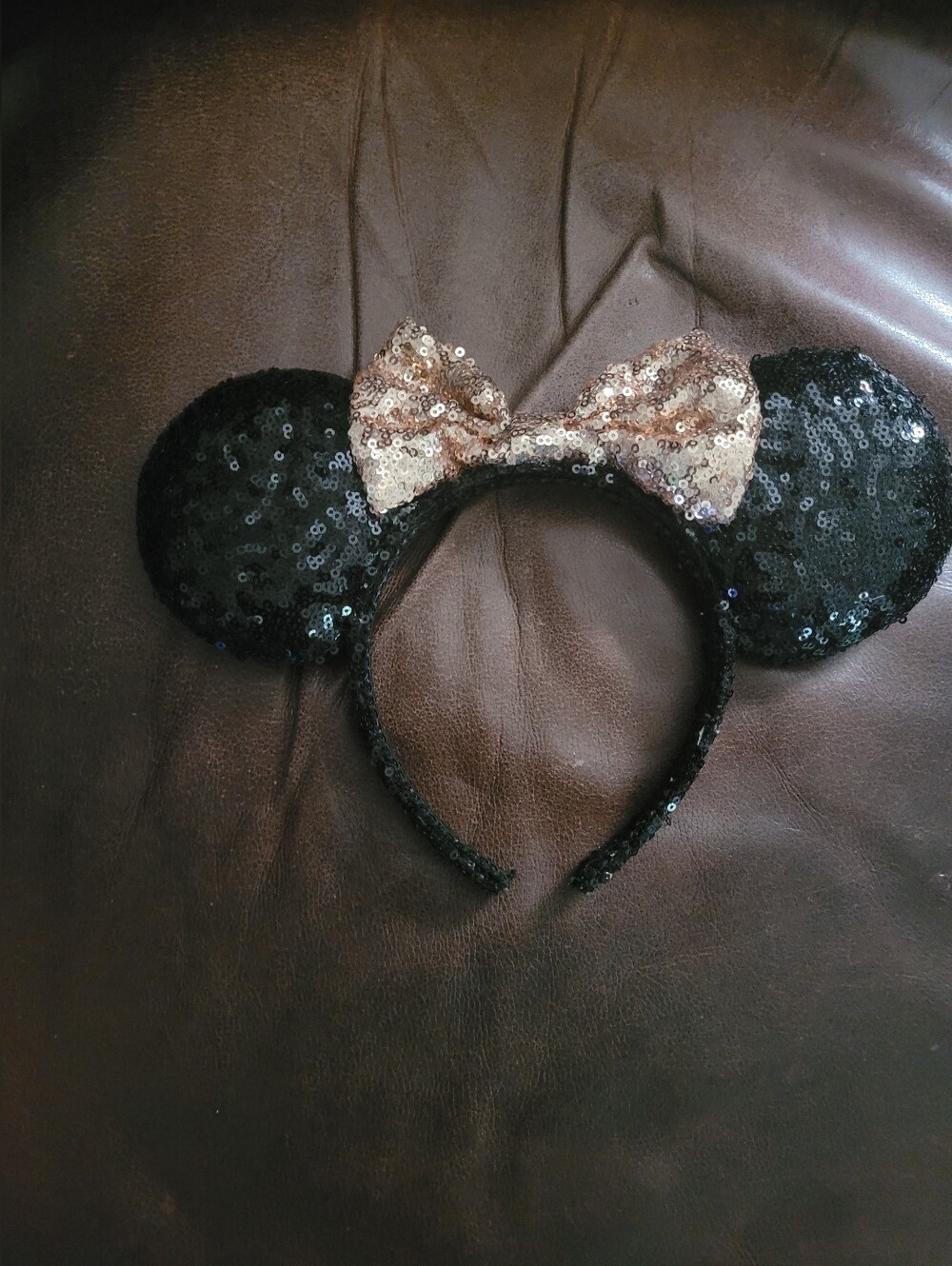 Disney Parks Minnie Mouse ears featuring a rose gold sequin bow and black sequin